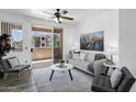 Cozy living room with sliding glass doors leading to a balcony with neighborhood views at 3830 E Lakewood E Pkwy # 2126, Phoenix, AZ 85048