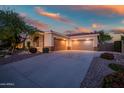Spacious three-car garage with ample parking space, complemented by desert landscaping and inviting exterior at 40123 N Majesty Trl, Anthem, AZ 85086