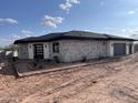 Well-appointed home with a stone facade, modern entry, two-car garage, and low maintenance landscaping at 4079 E Roosevelt St, Apache Junction, AZ 85119