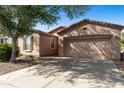 Inviting single-level home featuring a two-car garage and low-maintenance desert landscaping at 4245 E Ficus Way, Gilbert, AZ 85298