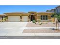 Charming single-story home featuring a three car garage, manicured landscaping, and a neutral color scheme at 4266 E Blue Sage Ct, Gilbert, AZ 85297