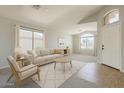 Bright living room features neutral decor, large windows, and stylish furnishings for comfortable living at 43727 W Wade Dr, Maricopa, AZ 85138