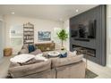 Modern living room with a large sectional sofa and a fireplace with entertainment center at 5109 E Helena Dr, Scottsdale, AZ 85254