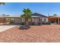 Charming single-story home with desert landscaping and a covered carport at 5243 W Vernon Ave, Phoenix, AZ 85035