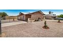 Charming brick home with unique arch detail, gravel landscaping, and fenced yard at 6430 W Thomas Rd, Phoenix, AZ 85033