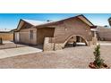 Lovely exterior of brick home showcasing unique carport arch and low-maintenance landscaping at 6430 W Thomas Rd, Phoenix, AZ 85033