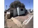 Single-story mobile home featuring brick trim and desert landscaping at 6439 W Myrtle Ave # 49, Glendale, AZ 85301