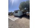 Single-story mobile home featuring brick trim and desert landscaping at 6439 W Myrtle Ave # 49, Glendale, AZ 85301