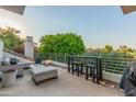 Relaxing outdoor patio area with comfortable seating, a bar table, and views of the lush green surroundings at 7222 E Gainey Ranch Rd # 245, Scottsdale, AZ 85258