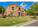 Charming two-story home with a red tile roof, stone accents, and a lush green lawn at 7236 W Electra Ln, Peoria, AZ 85383