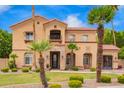 Charming two-story home with a red tile roof, stone accents, and lush landscaping at 7236 W Electra Ln, Peoria, AZ 85383