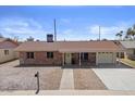 Inviting single story home with brick exterior, covered porch, and well-manicured front yard at 724 N Pine St, Gilbert, AZ 85233