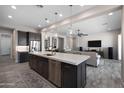 Open-concept living area with a view of the kitchen island and comfortable seating area at 8040 E Jaeger St, Mesa, AZ 85207