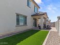 Private backyard featuring artificial turf, a covered patio, and a gravel border at 9230 E Scott Ave, Mesa, AZ 85212