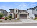 Inviting home exterior with a two-car garage, complemented by desert landscaping at 9230 E Scott Ave, Mesa, AZ 85212