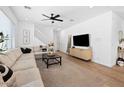 Bright living room showcasing a sectional sofa, modern décor, and ample natural light at 9230 E Scott Ave, Mesa, AZ 85212