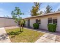 Inviting front yard with green lawn, mature landscaping, and a well-maintained facade at 1047 W Laguna Dr, Tempe, AZ 85282