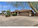 Exterior of a single story home featuring desert landscaping, a large driveway, and a two-car garage at 11101 W Wilshire Dr, Avondale, AZ 85392