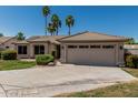 Inviting single-story home with a wide driveway and lush landscaping at 1343 W San Carlos Pl, Chandler, AZ 85248
