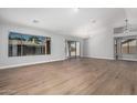 Spacious living room with wood-look floors, abundant natural light, and a sliding glass door at 1343 W San Carlos Pl, Chandler, AZ 85248
