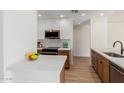 Bright kitchen with modern appliances, including a stainless steel microwave and white quartz countertops at 14239 N Edgeworth Dr # A, Fountain Hills, AZ 85268