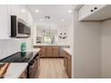 Modern kitchen featuring stainless steel appliances, light countertops, and wood-grain cabinetry at 14239 N Edgeworth Dr # A, Fountain Hills, AZ 85268