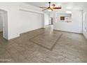 Expansive living room featuring tile flooring, recessed lighting, and an open design at 15162 W Monroe St, Goodyear, AZ 85338