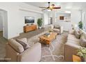 Bright living room with neutral colors, modern furnishings, and an open layout at 15162 W Monroe St, Goodyear, AZ 85338