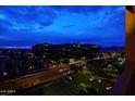 Balcony view showcases city lights at night and expansive buildings, creating a vibrant urban scene at 15215 N Kierland Blvd # 636, Scottsdale, AZ 85254