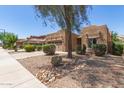 Charming single-story home featuring a well-manicured front yard and a two-car garage at 15674 W Mackenzie Dr, Goodyear, AZ 85395