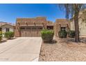 Charming single-story home featuring a well-manicured front yard and a two-car garage at 15674 W Mackenzie Dr, Goodyear, AZ 85395