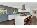 Modern kitchen featuring sleek white cabinets, tile backsplash, and stainless steel appliances at 1617 W Lamar Rd, Phoenix, AZ 85015