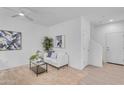 Bright living room with white walls, neutral carpet, ceiling fan, and a modern sofa set at 1727 E Chelsea Ln, Gilbert, AZ 85295