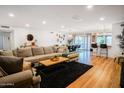 Spacious living room flows into the dining area, perfect for entertaining, with stylish decor and ample seating at 1831 E Cornell Dr, Tempe, AZ 85283