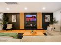 Modern living room features sleek accent wall and neutral tones, creating a stylish and comfortable space at 1831 E Cornell Dr, Tempe, AZ 85283
