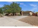 Lovely single-level home featuring a two-car garage, desert landscaping, and a cozy gated front patio at 18501 E Pine Valley Dr, Queen Creek, AZ 85142