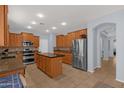 Well-equipped kitchen includes an island, stainless appliances, and custom cabinets at 18501 E Pine Valley Dr, Queen Creek, AZ 85142