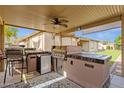 Built in outdoor kitchen with stainless steel grill, granite countertops and beverage cooler at 18501 E Pine Valley Dr, Queen Creek, AZ 85142