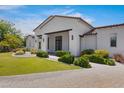 Stunning single-Gathering home with a beautifully landscaped front yard and brick driveway at 24434 S 201St Ct, Queen Creek, AZ 85142
