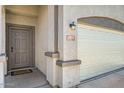 Close-up of home's front door and two-car garage with welcome mat and address plaque at 2853 E Cathy Dr, Gilbert, AZ 85296