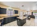 Open-concept kitchen with dark cabinetry, granite counters, and adjacent dining area at 2853 E Cathy Dr, Gilbert, AZ 85296