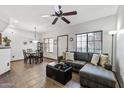 Cozy living room with a large sectional sofa, ceiling fan, and tile floors at 3150 E Beardsley Rd # 1023, Phoenix, AZ 85050