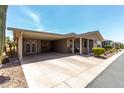 Spacious carport providing covered parking and additional storage with exterior door at 3301 S Goldfield Rd # 6050, Apache Junction, AZ 85119