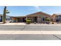 Charming single-story home with a covered porch and well-maintained landscaping at 3301 S Goldfield Rd # 6050, Apache Junction, AZ 85119
