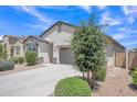 Attractive single-Gathering home featuring desert landscaping, a paved driveway and a two-car garage at 38150 W San Sisto Ave, Maricopa, AZ 85138