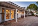 Welcoming front porch with stone flooring, cozy seating, and a clear view into the brightly lit interior of the home at 3824 N 50Th Pl, Phoenix, AZ 85018