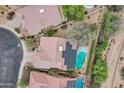Birds-eye view of a home featuring a private pool, desert landscaping, and rooftop solar panels at 4449 E Rancho Caliente Dr, Cave Creek, AZ 85331