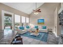 Bright living room with high ceilings, a ceiling fan, large windows and a stylish blue rug at 4449 E Rancho Caliente Dr, Cave Creek, AZ 85331