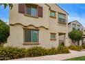 Charming two-story home featuring a decorative wrought iron balcony and colorful yellow flowering bushes at 4853 S Charger --, Mesa, AZ 85212