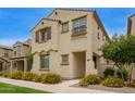 Charming two-story home featuring a decorative wrought iron balcony and colorful yellow flowering bushes at 4853 S Charger --, Mesa, AZ 85212